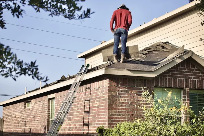 Professional roofer working on a residential roof in Hay Creek